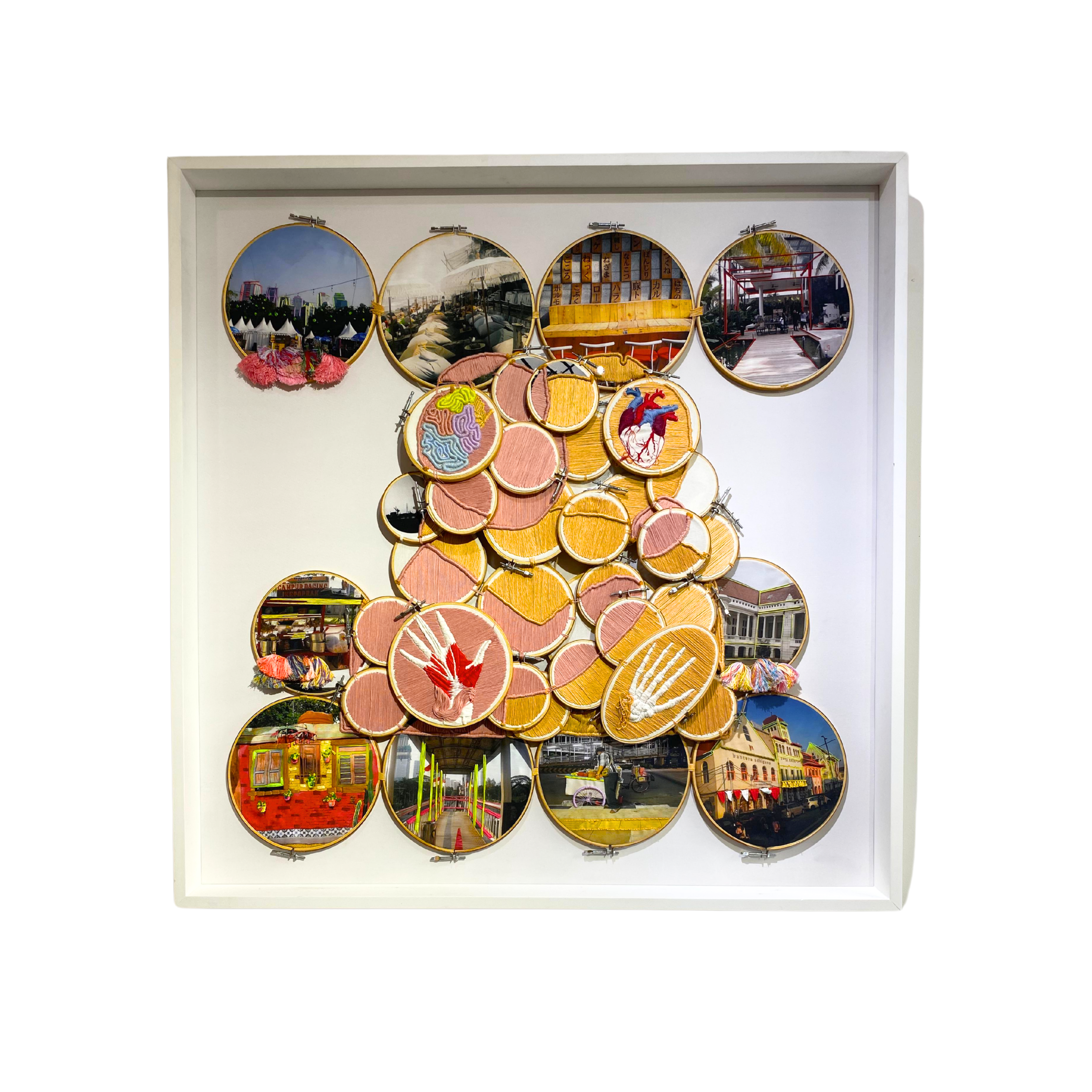 A sophisticated original art mixed media piece titled "Interaksi" by Gracia Veronica at 2madison Gallery. This Contemporary Fiber Art features a collage of photographic urban scenes of Jakarta combined with intricate embroidery hoops, representing the creative diversity of Art Gallery Indonesia and Affordable art Indonesia.